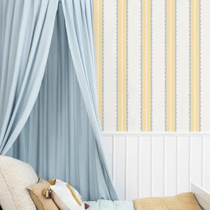 May include: A light blue canopy bed with pillows and a mustard-colored blanket. The bed is set against a wall with vertical stripes in yellow, white, and gray. The image includes the text "little forest KIDS".