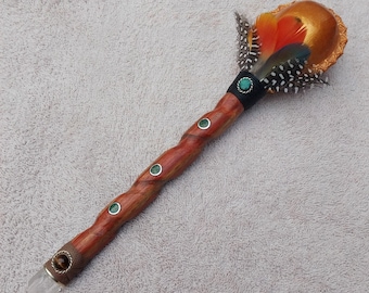 shamanic rattle made of palo sangre, inlaid with turquoise and feathers, crystal and part of the rattle in leather and tiger's eye stone