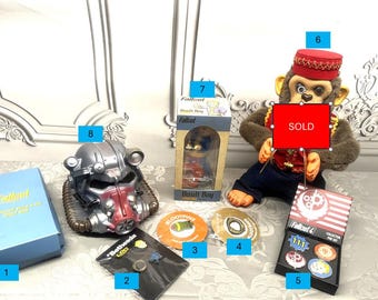 Choice of 8 Fallout Goodies that include Bobble head, Pens, Loot Crate items, Power Armor Banks and Jolly Chimp  Monkey