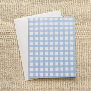 May include: A white card with a blue and white gingham pattern.
