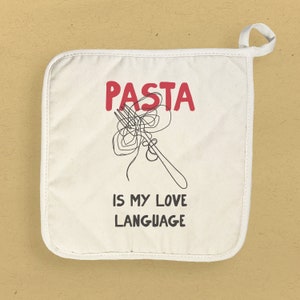 May include: White cotton pot holder with a red graphic that says "PASTA IS MY LOVE LANGUAGE" and a black and white illustration of a fork with spaghetti.