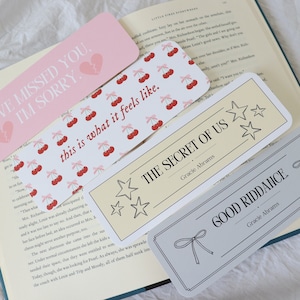 May include: Four different bookmark designs with various colors and patterns. The bookmarks feature text that reads "I've missed you, I'm sorry", "This is what it feels like", "The Secret of Us", and "Good Riddance".