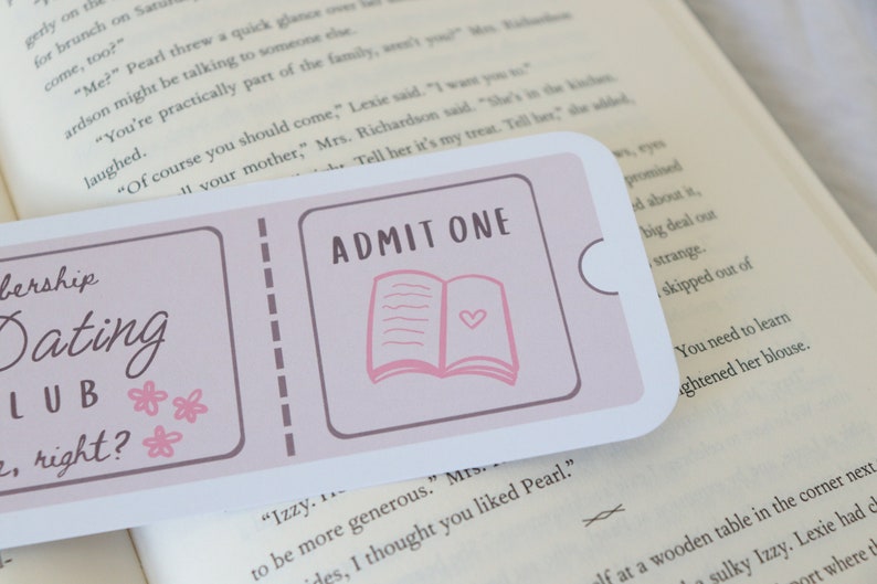 May include: A pink and white bookmark with the text "Membership Dating Club, right?" and "ADMIT ONE" with a pink open book illustration.