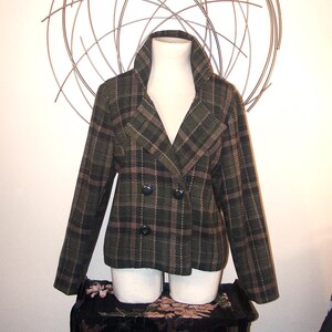 May include: A double-breasted plaid jacket with a brown and green plaid pattern. The jacket has a collar and long sleeves.