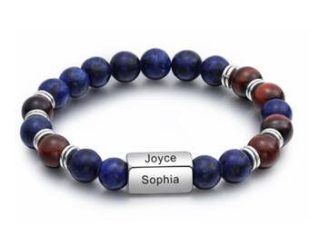 May include: A beaded bracelet with blue and red stones and a silver bar with the names "Joyce" and "Sophia" engraved on it.