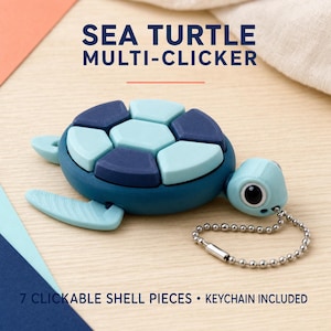 May include: A sea turtle multi-clicker keychain featuring a dark blue base and a shell composed of seven light blue and dark blue clickable pieces. The turtle has a light blue head with a black eye and includes a silver metal ball chain.