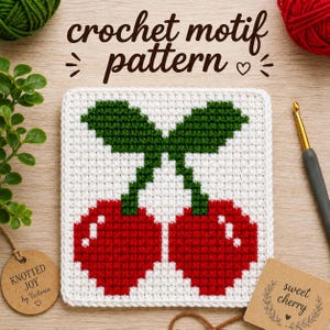 May include: A square crochet motif featuring a pixelated cherry design with two red cherries and green stems on a white background. The text "crochet motif pattern" is displayed above the motif, with a crochet hook and two tags nearby.