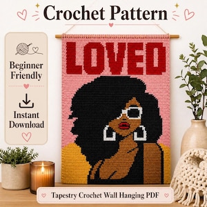 May include: A crochet wall hanging tapestry featuring the word LOVED in bold red letters over a pink background. The design depicts a person with dark skin, voluminous black hair, white-rimmed sunglasses, and large white hoop earrings.