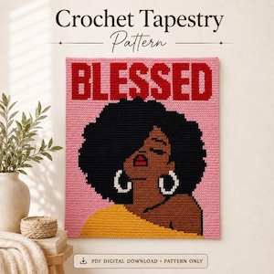 May include: A crochet tapestry pattern featuring the text BLESSED in red letters on a pink background. The design depicts a person with dark skin, a large black afro hairstyle, red lips, and white hoop earrings, wearing a yellow top.