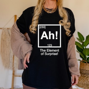 Funny Science T-Shirt – “Ah! The Element of Surprise” Shirt | Chemistry Teacher Gift | STEM Nerd Tee | Periodic Table Joke Shirt
