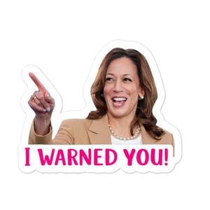 May include: A sticker featuring a smiling woman pointing her finger. She is wearing a tan blazer and a pearl necklace. The text "I WARNED YOU!" is in bright pink letters across the bottom of the sticker.