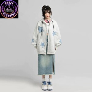 May include: A light gray zip-up hoodie with blue star patches on the sleeves and chest. The outfit includes a denim skirt and sneakers. The image also features the logo for Crazy Clothing Etsy Shop.