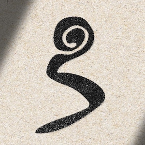 May include: A black ink graphic symbol featuring a circular spiral at the top that transitions into a curved, tapering tail. The design is printed on a textured, light beige paper surface with a visible grain and a soft shadow across the top left.