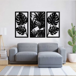 May include: Three black metal wall decor panels featuring cut-out designs of tropical leaves. The panels are arranged in a row on a white wall above a gray couch.