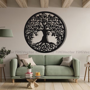 May include: Black metal tree of life wall decor with intricate details, hanging on a white wall in a living room setting with a green sofa, wooden coffee table, and potted plants.