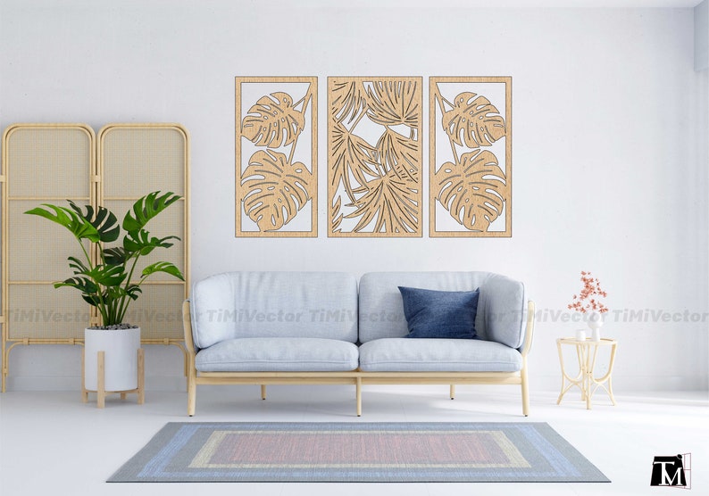 May include: Three wooden wall decor panels with a tropical leaf design. The panels are light brown and feature cut-out designs of monstera leaves and palm fronds.