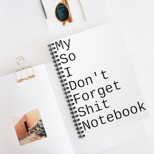 May include: A white spiral-bound notebook featuring the black text My So I Don't Forget Shit Notebook on the cover, accompanied by a gold metal binder clip and a pair of brown-rimmed sunglasses resting on a white surface.