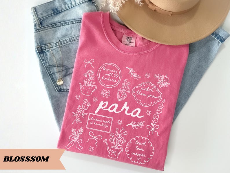 May include: A pink t-shirt featuring white line art illustrations of flowers, watering cans, and bows. The text reads: learning with kindness, watch them grow, para, planting seeds of knowledge, and teach love inspire in various frames.