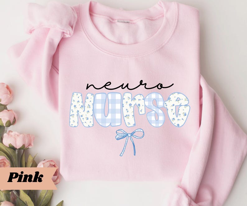 May include: A light pink sweatshirt with the words "neuro nurse" in black script and blue floral and gingham print. A blue bow graphic is below the word "nurse". The word "Pink" is in a pink banner in the lower left corner.