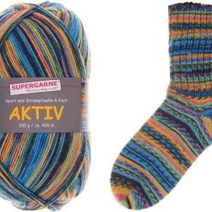 May include: A ball of Aktiv yarn with a matching knitted sock. The yarn is multi-colored with blue, orange, yellow, and black stripes. The sock has a similar striped pattern. The yarn label reads "SUPERGARNE AKTIV".