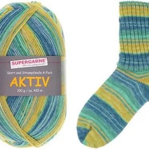 May include: A ball of multi-colored yarn and a matching knitted sock. The yarn is labeled "SUPERGARNE AKTIV" and is a blend of yellow, blue, and green. The sock has horizontal stripes of the same colors. The yarn is 100 g / 420 m.
