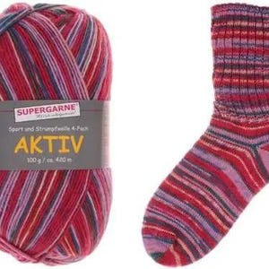May include: A ball of red, pink, and blue striped yarn next to a matching sock. The yarn label reads "SUPERGARNE AKTIV 100 g / ca. 420 m". The sock and yarn are designed for knitting or crocheting projects.