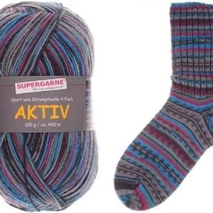 May include: A ball of Aktiv yarn and a matching sock. The yarn is a mix of gray, blue, and purple. The sock has a striped pattern in similar colors. The yarn label reads "SUPERGARNE AKTIV 100 g/ca. 420 m".