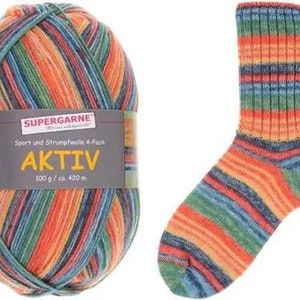 May include: A ball of Aktiv yarn and a knitted sock. The yarn is multi-colored with orange, green, blue, and red stripes. The sock is also striped with the same colors. The yarn label reads "SUPERGARNE AKTIV 100 g / ca. 420 m."