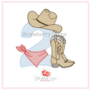 May include: An embroidered design featuring a cowboy hat, cowboy boots, and a red bandana, with the number 2 in light blue. The design includes the text "Strawberry Layne" in two places.