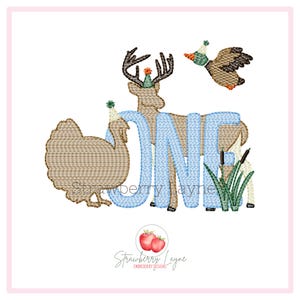 May include: An embroidered design featuring a deer, turkey, and duck, all wearing party hats, with the word "ONE" in blue. The design includes cattails and is set against a white background. The Strawberry Layne logo is at the bottom.