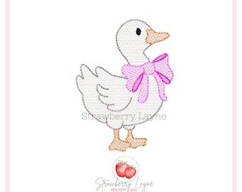 May include: An embroidered design of a white goose wearing a pink bow. The goose has a black eye and orange feet. The text "Strawberry Layne" is below the goose and the Strawberry Layne logo is at the bottom.