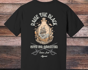 May include: Black t-shirt with a graphic of a ship in a bottle and the text "Raise the Black Give No Quarter Calico Jack Apparel".