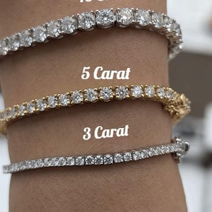 May include: Three diamond tennis bracelets on a wrist, labeled 10 Carat, 5 Carat, and 3 Carat.