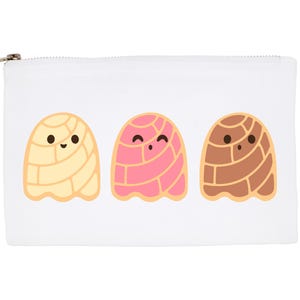 May include: White zippered pouch featuring three cartoon concha pastries in yellow, pink, and brown. Each pastry has a smiling face. The pouch has a silver zipper.