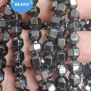 May include: A strand of black faceted gemstone beads. The beads are in the shape of a cube with many facets. The beads are strung on a clear string. The beads are approximately 8mm in diameter.  WK DIY Jewelry Beads.