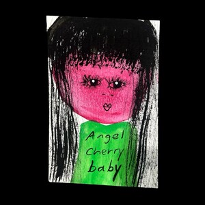 May include: A mixed-media artwork featuring a stylized face with a pink complexion, black hair, and long eyelashes. The artwork includes the text "Angel Cherry baby" on a green background.