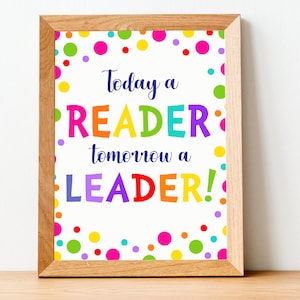 Peut inclure: Une impression encadrée avec un fond blanc et des pois multicolores. Le texte dit "Aujourd'hui un LECTEUR, demain un LEADER !"