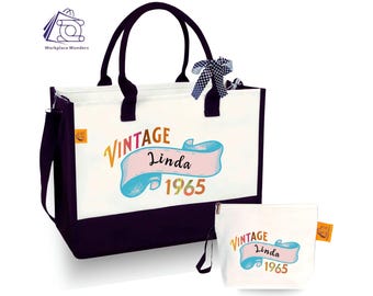 May include: A white canvas tote bag with black handles and a black bottom. The bag has a colorful vintage design with the text "Vintage Linda 1965". The bag comes with a matching smaller white canvas pouch with a zipper closure.