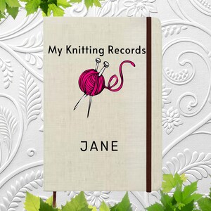 May include: A beige notebook with the title "My Knitting Records" and a pink yarn ball and needles illustration. The name "JANE" is printed below. A dark brown vertical stripe is on the right side.