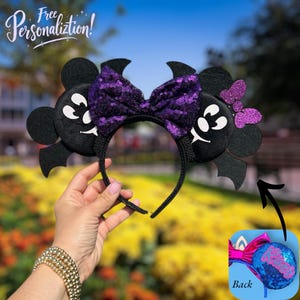 May include: Black mouse ear headband with a purple sequined bow and a smaller purple glitter bow. The ears have bat wings and white facial features. The text "Free Personalization!" is in the background.