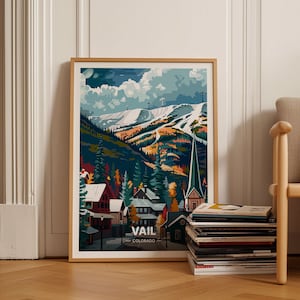 May include: A framed illustration of a snowy mountain landscape with a small town at the base. The town has colorful buildings and a tall church steeple. The text "VAIL COLORADO" is at the bottom of the image.