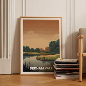 Puede incluir: Una impresión enmarcada de una escena de paisaje con un río, árboles y un pequeño barco. La impresión se titula "DEDHAM VALE".