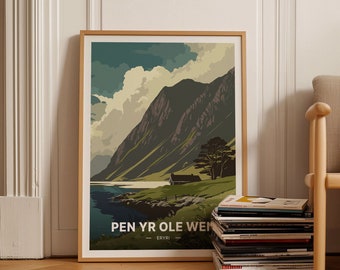 May include: A framed poster with a vintage travel illustration of a mountain range and a lake. The poster is titled "Pen Yr Ole Wen - Eryri".