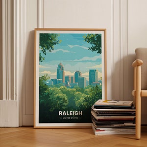 May include: A framed poster with a colorful illustration of the Raleigh skyline. The poster has the text "Raleigh - United States" at the bottom.