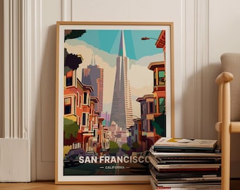 May include: A framed poster with a colorful illustration of a street in San Francisco, California. The Transamerica Pyramid is the focal point of the image, with other buildings and houses lining the street. The text "SAN FRANCISCO - CALIFORNIA" is at the bottom of the poster.