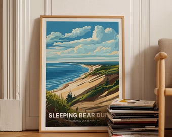 May include: A framed poster with a colorful illustration of Sleeping Bear Dunes National Lakeshore. The poster features a panoramic view of the dunes, a sandy beach, and a blue lake with a cloudy sky.