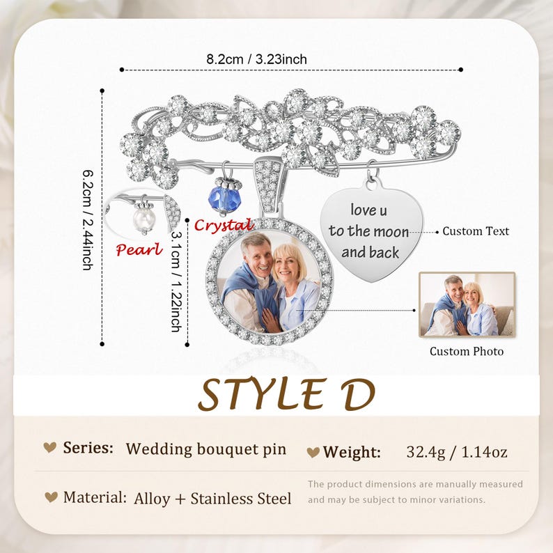 May include: A silver-toned wedding bouquet pin measuring 3.23 inches by 2.44 inches. It features a floral design with clear stones, a circular photo frame, a heart-shaped charm engraved with 'love u to the moon and back', and a blue crystal bead.