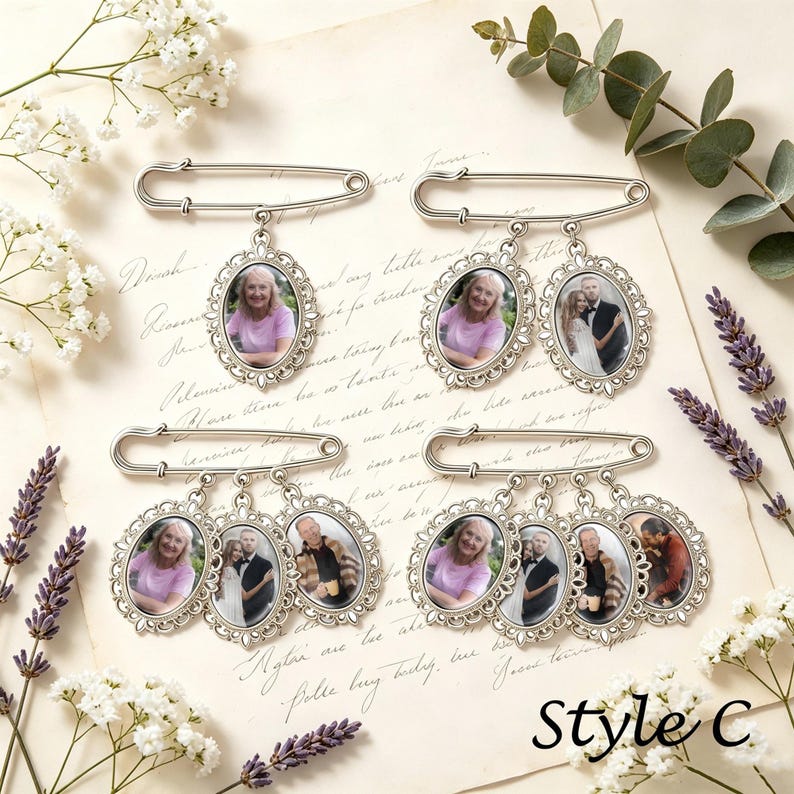 May include: Four silver-toned metal safety pins, each featuring dangling oval-shaped photo frames with ornate filigree borders. The frames contain various portrait photographs of individuals and couples. The text Style C is visible in the corner.