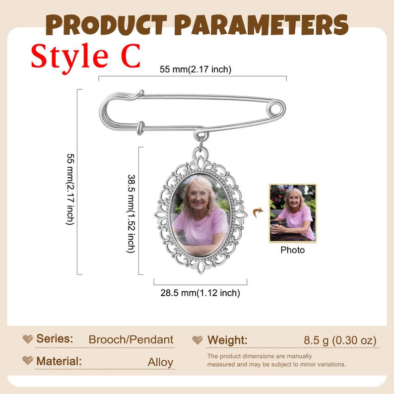 May include: A silver-toned brooch featuring an oval pendant with an ornate filigree frame containing a photograph of a person in a pink shirt. The brooch measures 2.17 inches in length, with the pendant measuring 1.52 by 1.12 inches and weighing 0.30 oz.