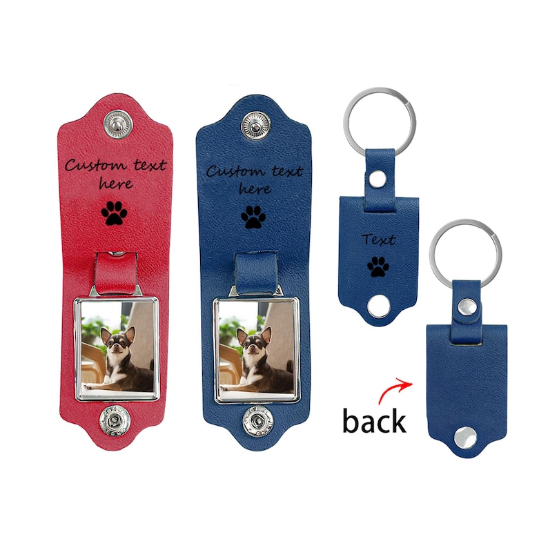 May include: Two leather keychains with metal frames, one red and one blue, each featuring a photo of a dog, a paw print icon, and the text Custom text here. Two additional blue leather keychains are shown, one with a paw print and Text.